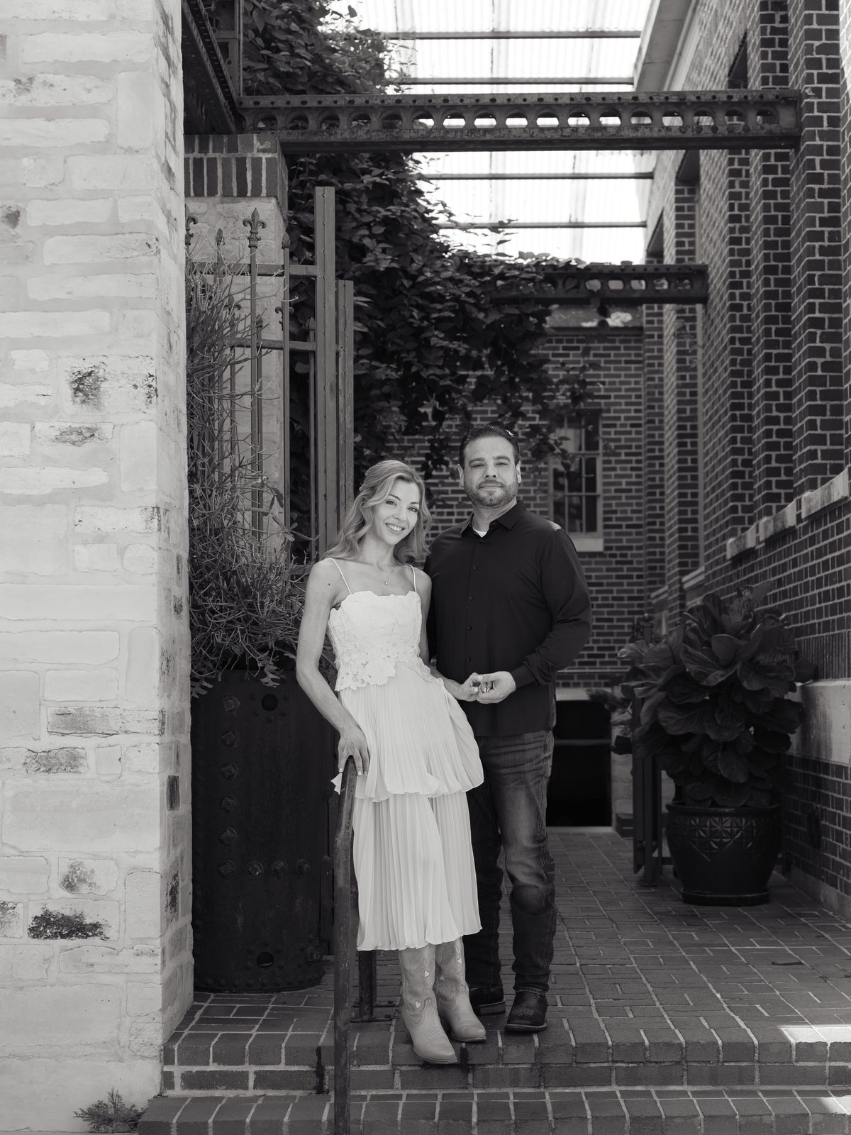 Chris and Brittney in a brick courtyard