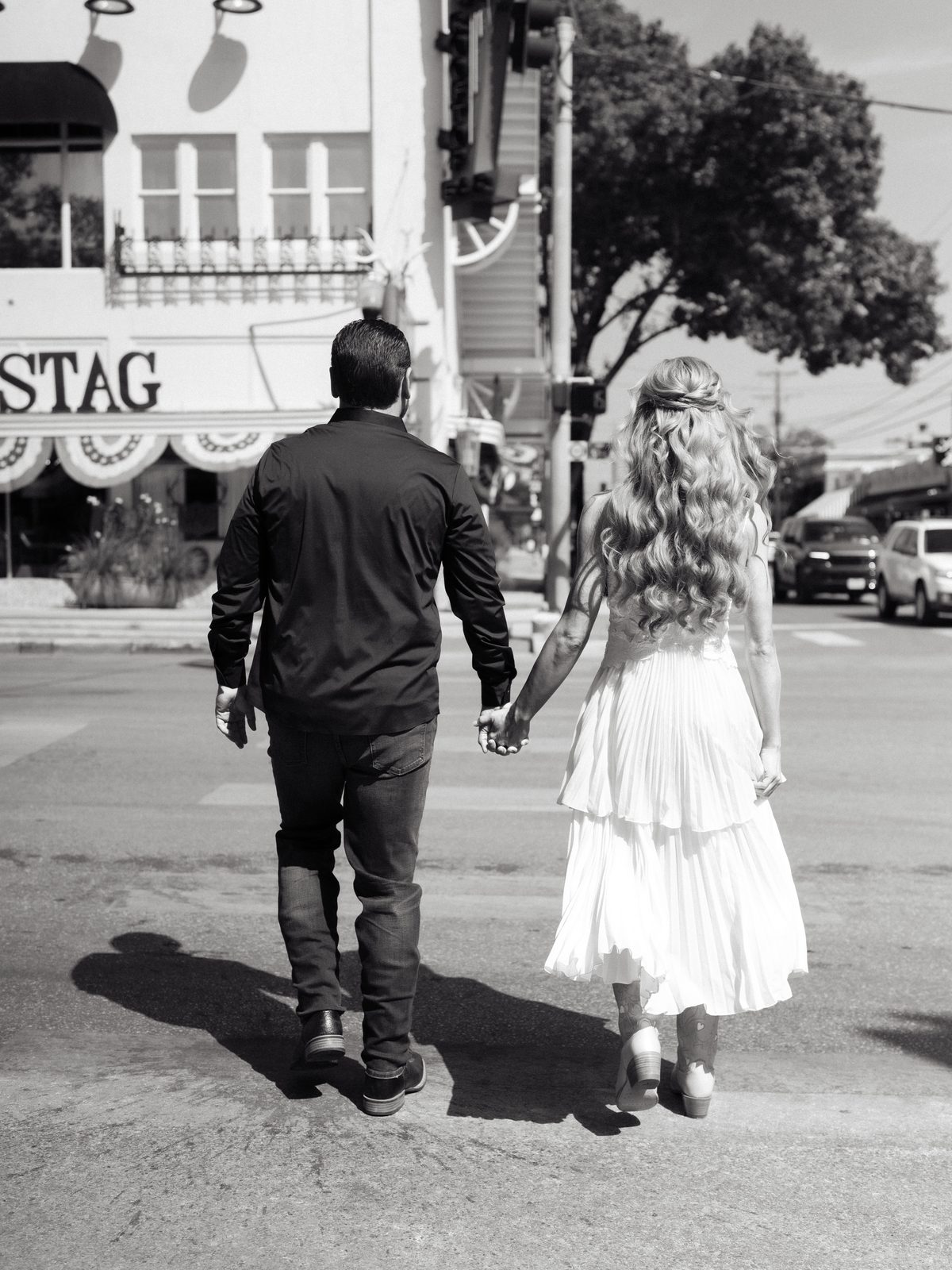 Chris and Brittney walking hand in hand down Main Street